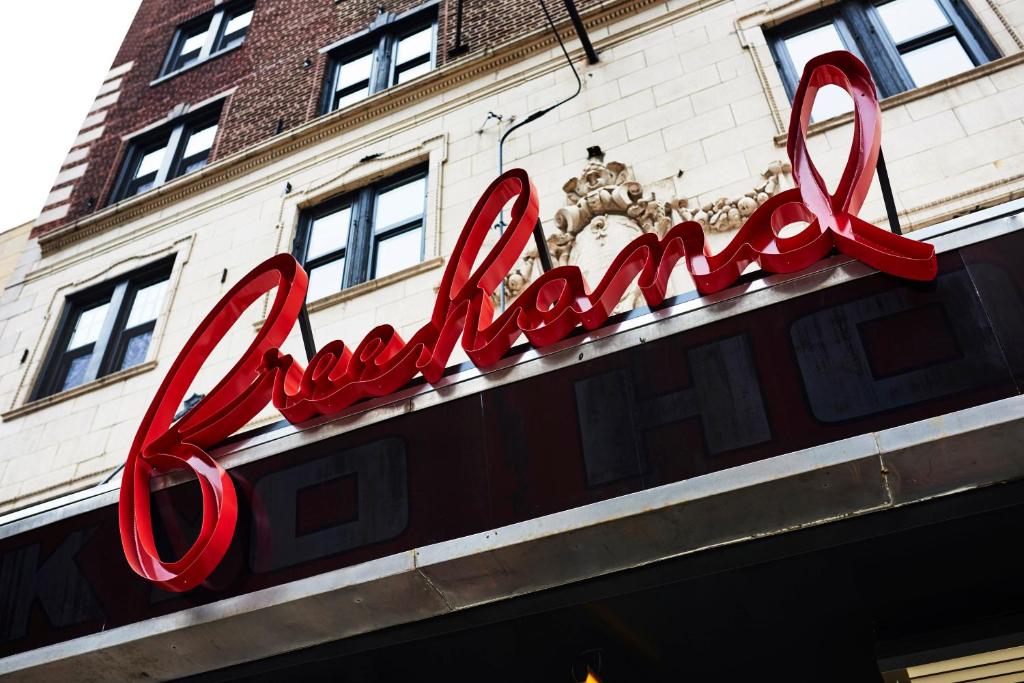 The red script Freehand marquee over the historic entrance