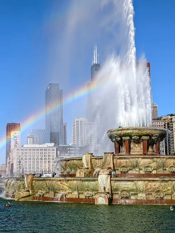 Buckingham Fountain with a rainbow and the Chicago skyline in Grant Park